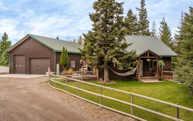 view of front of house with a front yard, an outdoor structure, and a garage