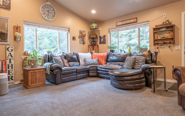 living room featuring lofted ceiling, carpet floors, and a healthy amount of sunlight