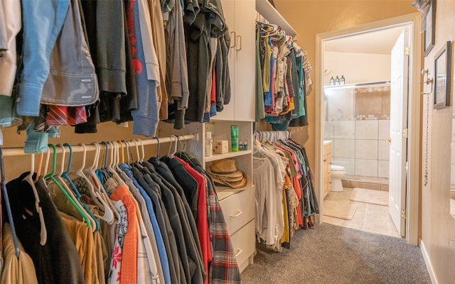 walk in closet with light tile patterned floors