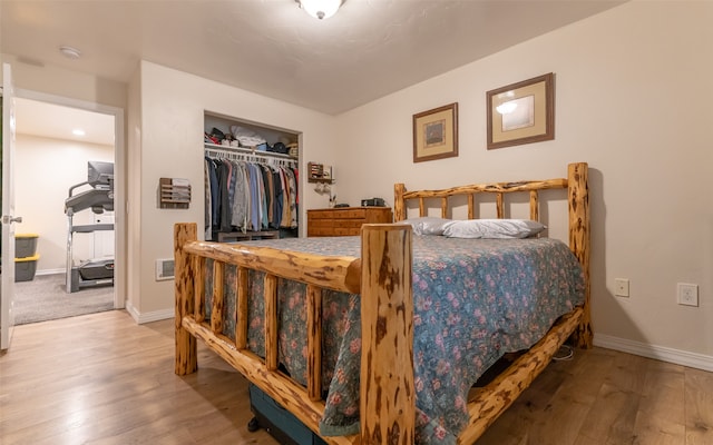 bedroom with a closet and hardwood / wood-style floors