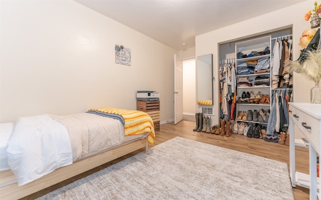 bedroom featuring light hardwood / wood-style floors and a closet