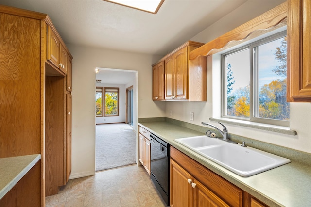 kitchen with dishwasher, light carpet, and sink