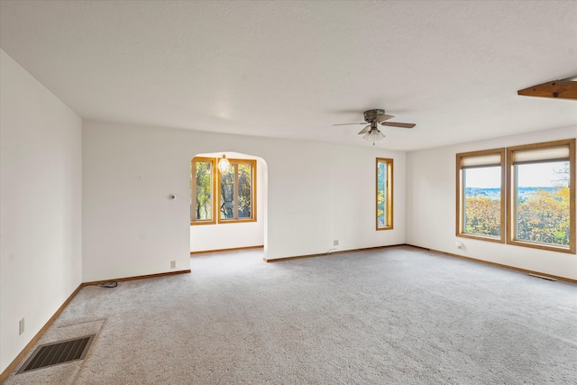 spare room featuring carpet and ceiling fan