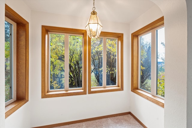 unfurnished sunroom with an inviting chandelier