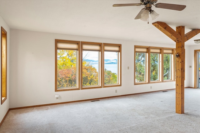 carpeted spare room featuring ceiling fan