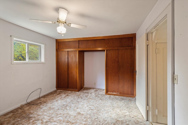 unfurnished bedroom featuring ceiling fan and light carpet