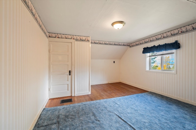 interior space featuring lofted ceiling and hardwood / wood-style flooring