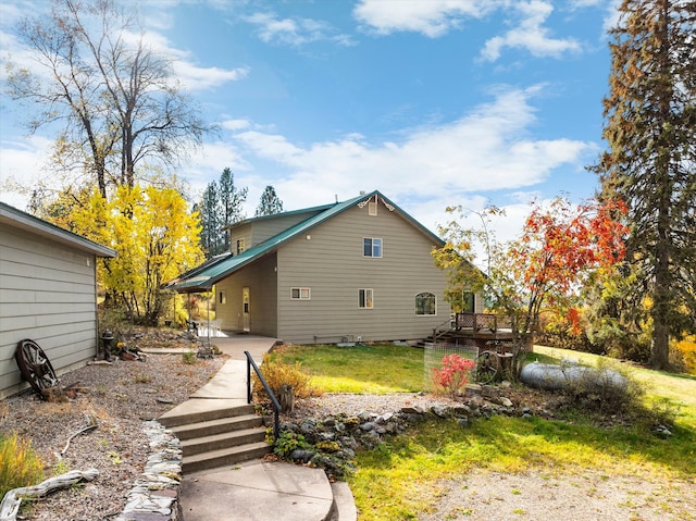 rear view of property featuring a yard