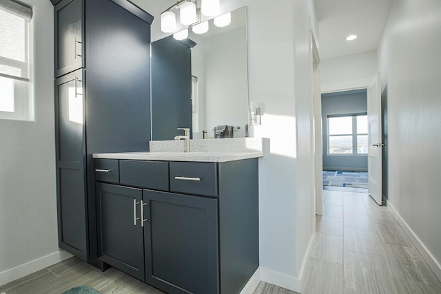 bathroom with baseboards and vanity