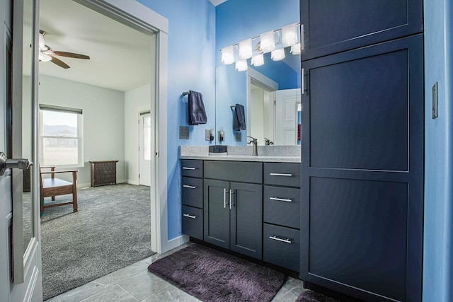 bathroom featuring a ceiling fan, vanity, and baseboards