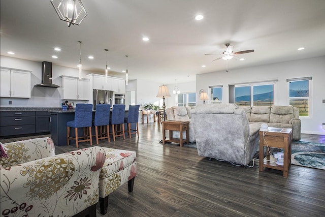 living area featuring recessed lighting, plenty of natural light, dark wood-style floors, and ceiling fan