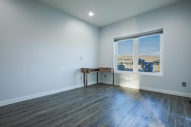 unfurnished room featuring dark wood-type flooring, baseboards, and recessed lighting