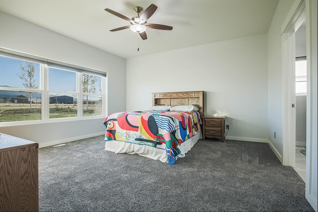carpeted bedroom with baseboards and a ceiling fan