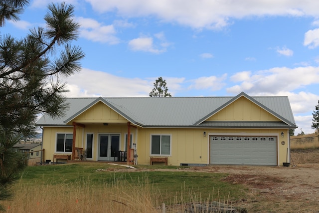 ranch-style house with french doors and a garage