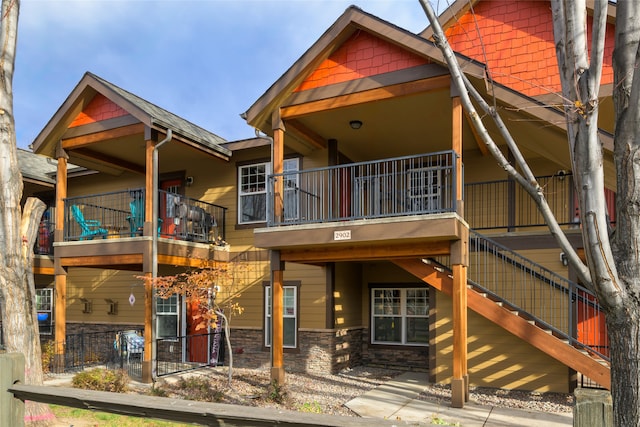 back of house featuring a patio area and a balcony