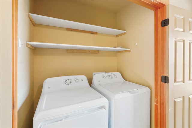 clothes washing area featuring separate washer and dryer