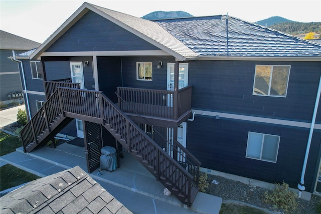 2726 Overlook Blvd, Helena, MT 59601 - rear view of property with stairway, a mountain view, a patio area, and roof with shingles