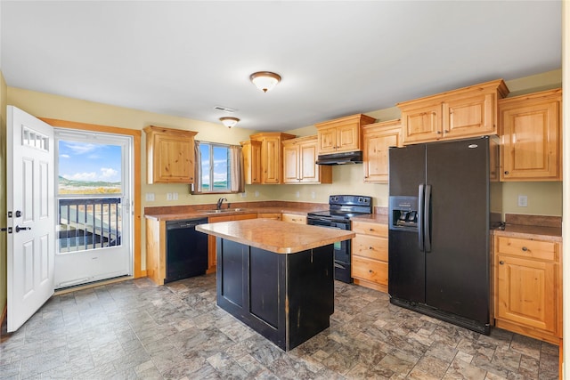 2726 Overlook Blvd, Helena, MT 59601 - kitchen featuring black appliances, under cabinet range hood, light countertops, and stone finish floors