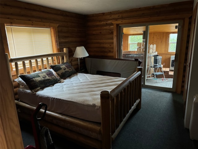 carpeted bedroom featuring access to exterior and rustic walls