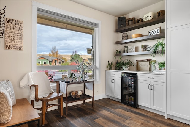 bar with white cabinetry, dark hardwood / wood-style floors, and beverage cooler