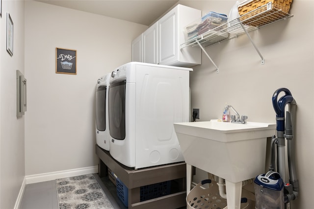 laundry area with cabinets and washer and clothes dryer