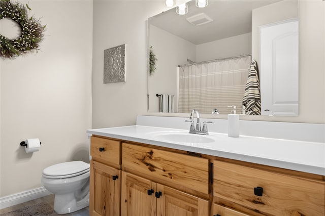 bathroom featuring vanity, hardwood / wood-style floors, and toilet