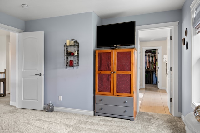 bedroom with light carpet and a closet