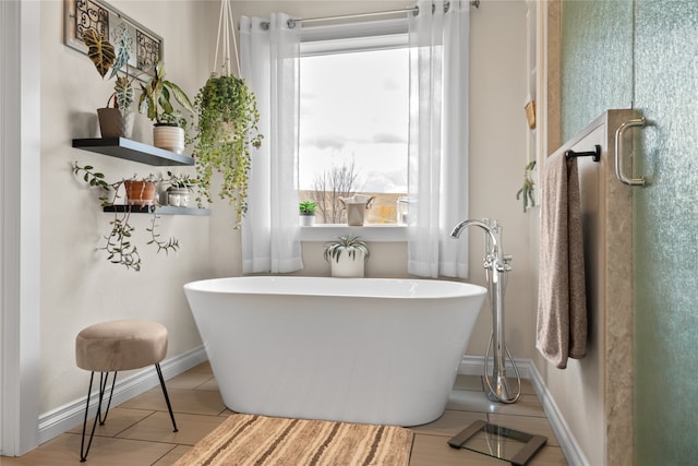 bathroom with tile patterned floors and a bathing tub