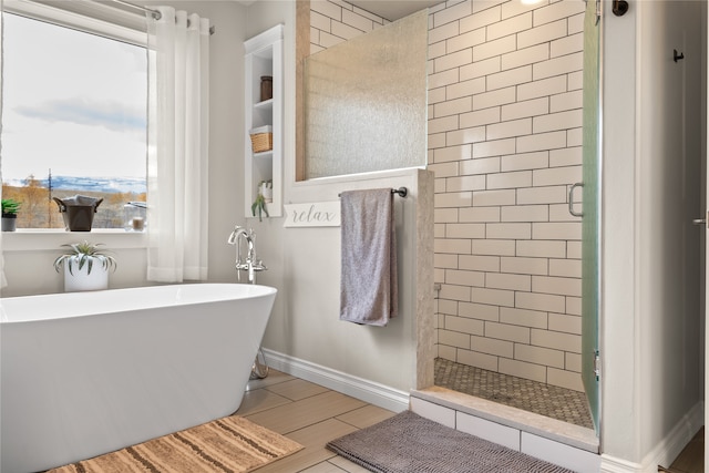 bathroom featuring shower with separate bathtub