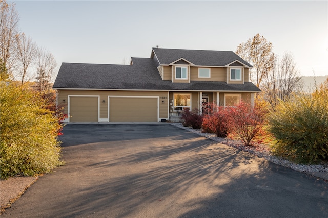 view of front of home with a garage and a porch