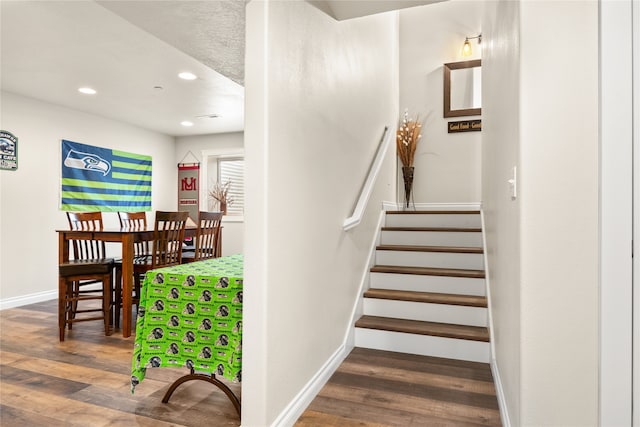 stairway with hardwood / wood-style floors