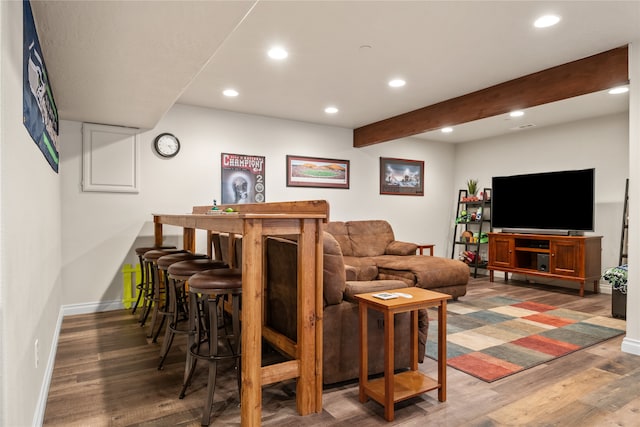 living room with beam ceiling, bar, and wood-type flooring