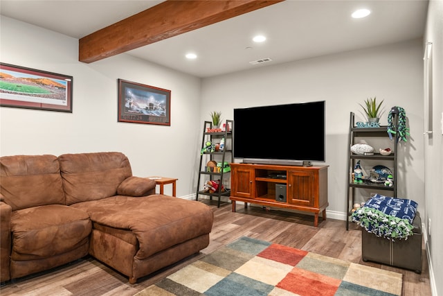 living room with beam ceiling and light hardwood / wood-style floors