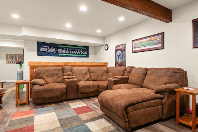 living room with beamed ceiling, hardwood / wood-style floors, and bar area