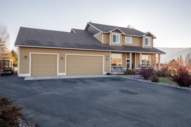 view of front of home featuring a porch and a garage