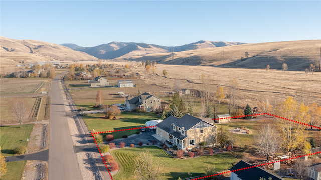 birds eye view of property featuring a mountain view and a rural view