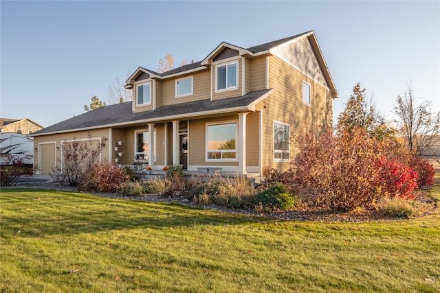 view of front of property featuring a front yard and a garage