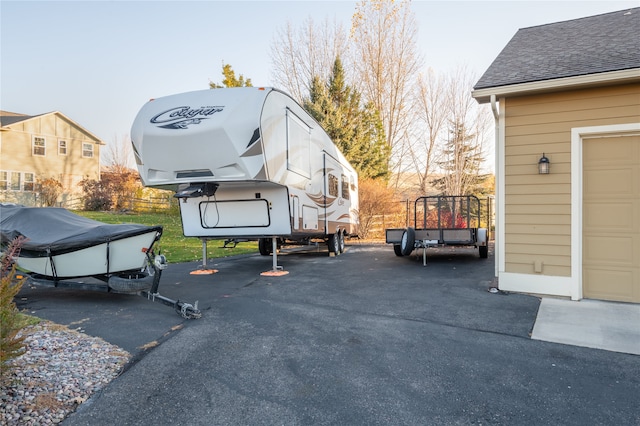 view of vehicle parking with a garage