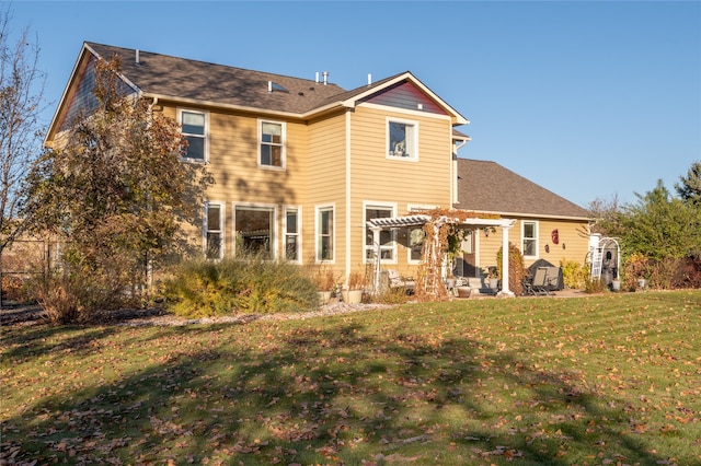 back of house featuring a pergola, a patio area, and a lawn