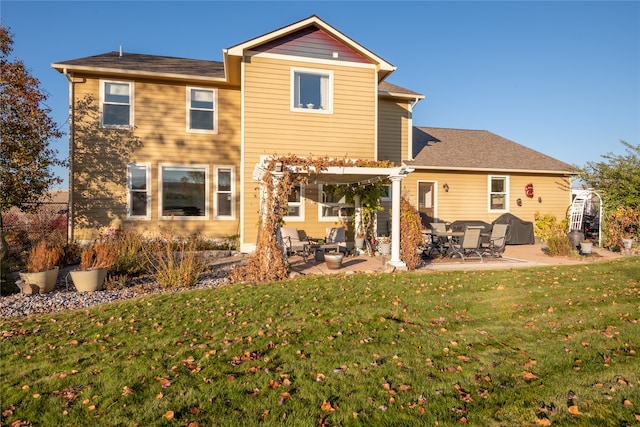 back of house with a patio area and a lawn