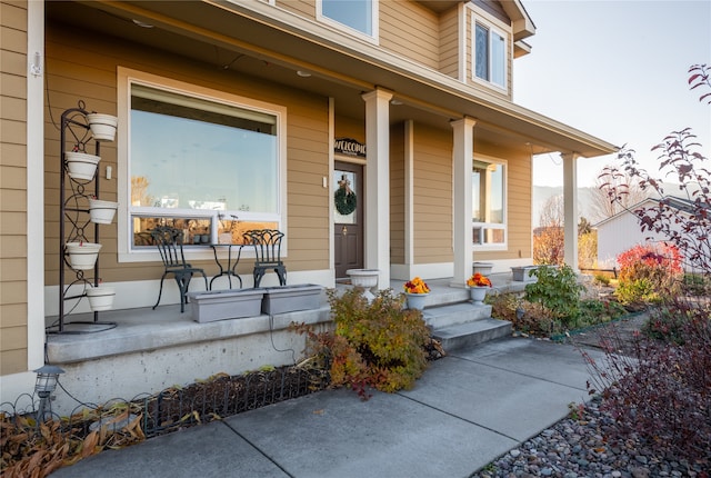 view of exterior entry featuring covered porch