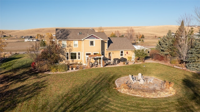 rear view of house with a patio and a yard