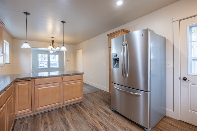 kitchen featuring ceiling fan, dark wood-type flooring, kitchen peninsula, stainless steel fridge, and decorative light fixtures