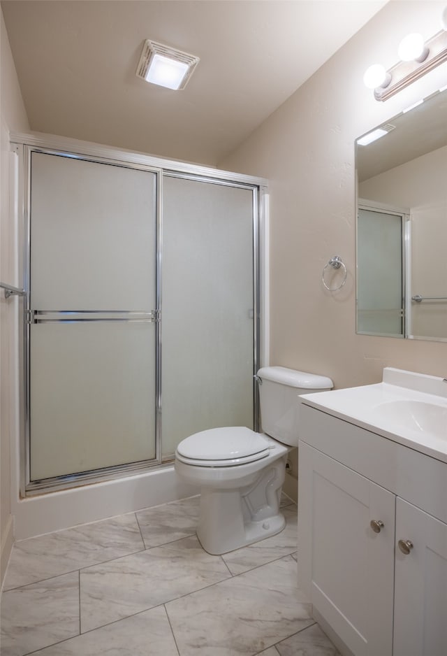 bathroom with lofted ceiling, vanity, toilet, and a shower with shower door