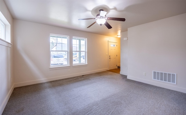 unfurnished room featuring ceiling fan and carpet floors