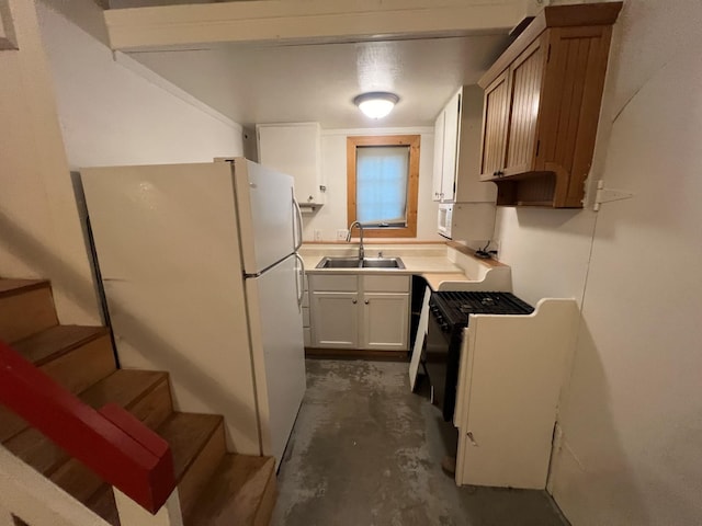 9330 US Highway 2 W, Marion, MT 59925 - kitchen with a sink, white appliances, unfinished concrete floors, light countertops, and white cabinets