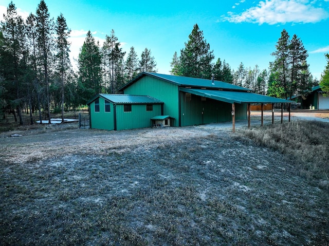 9330 US Highway 2 W, Marion, MT 59925 - view of property exterior featuring metal roof and driveway