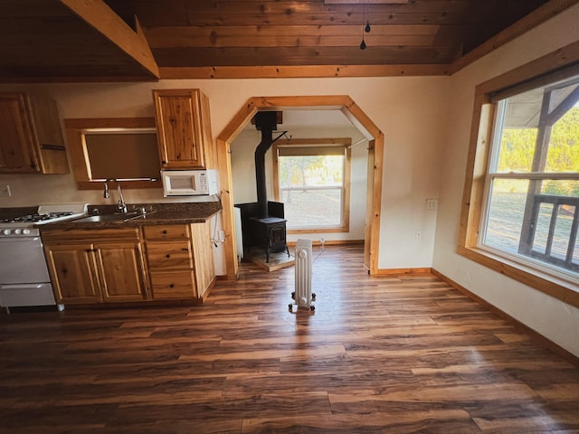 9330 US Highway 2 W, Marion, MT 59925 - kitchen with white appliances, a sink, dark wood-style floors, plenty of natural light, and wooden ceiling
