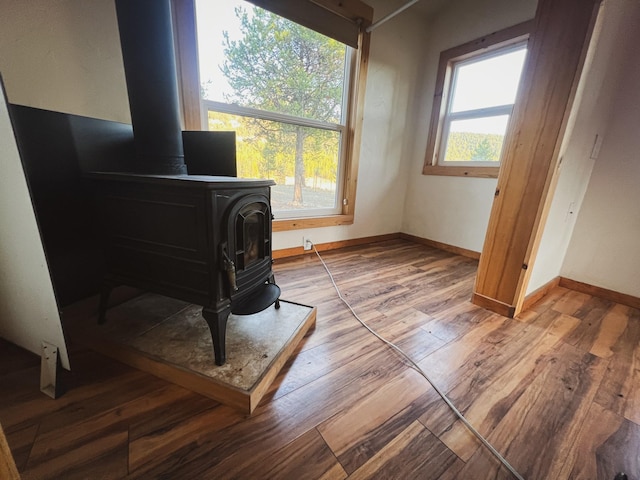 9330 US Highway 2 W, Marion, MT 59925 - office space featuring a wood stove, wood finished floors, and baseboards