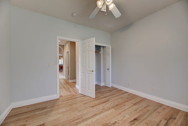 unfurnished bedroom featuring ceiling fan and light wood-type flooring